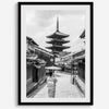 Timeless Kyoto scene with traditional architecture and kimono-clad woman in black and white.