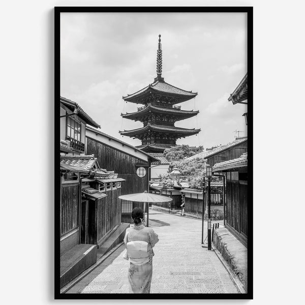 Timeless Kyoto scene with traditional architecture and kimono-clad woman in black and white.