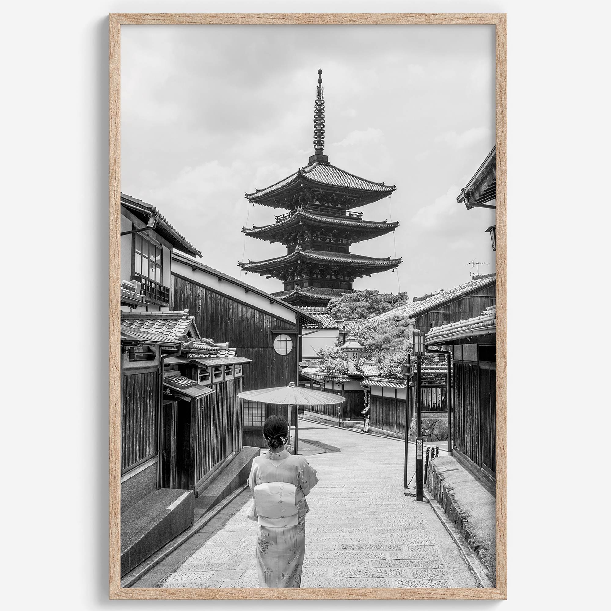 Timeless Kyoto scene with traditional architecture and kimono-clad woman in black and white.