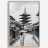 Timeless Kyoto scene with traditional architecture and kimono-clad woman in black and white.