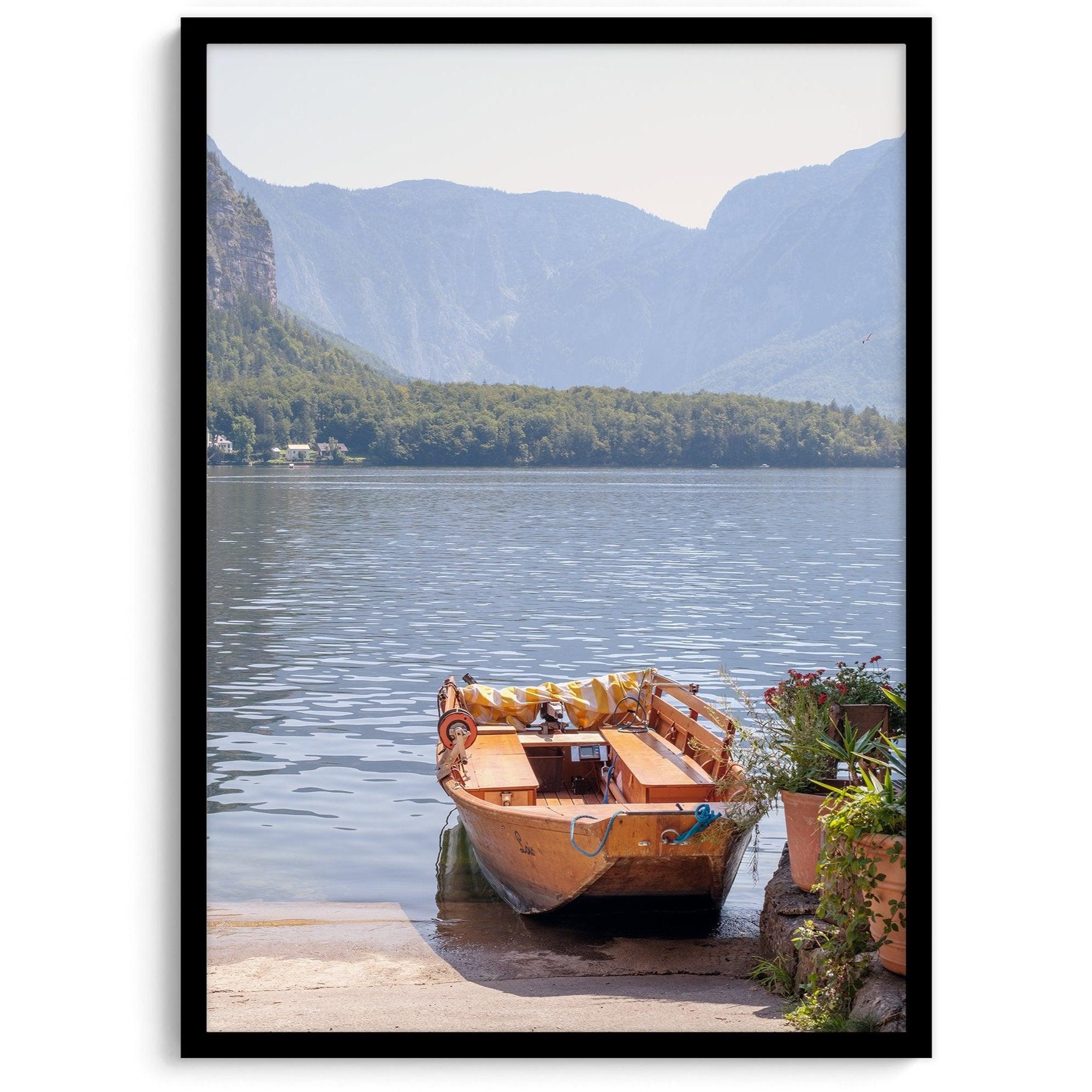 Lake house decor featuring a serene wooden boat on Lake Hallstatt, with mountains and lush greenery, perfect for tranquil spaces.