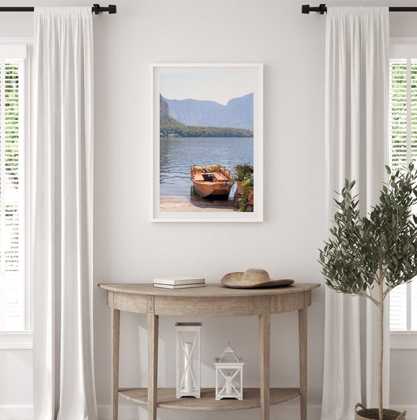 Lake house decor featuring a serene wooden boat on Lake Hallstatt, with mountains and lush greenery, perfect for tranquil spaces.