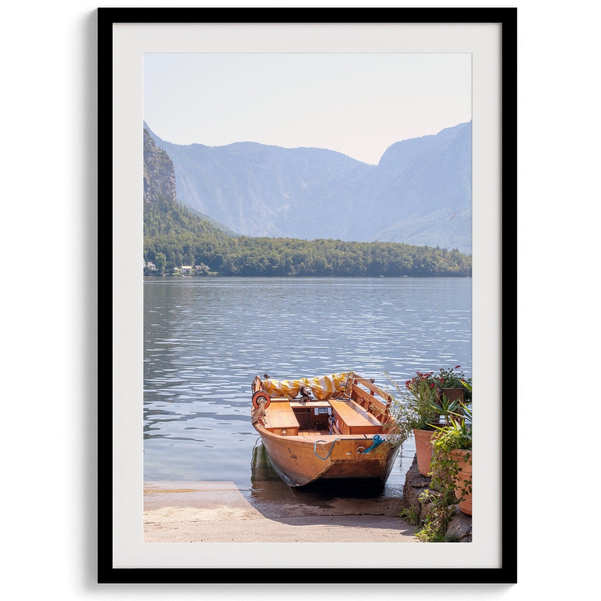 Lake house decor featuring a serene wooden boat on Lake Hallstatt, with mountains and lush greenery, perfect for tranquil spaces.