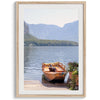 Lake house decor featuring a serene wooden boat on Lake Hallstatt, with mountains and lush greenery, perfect for tranquil spaces.