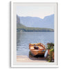 Lake house decor featuring a serene wooden boat on Lake Hallstatt, with mountains and lush greenery, perfect for tranquil spaces.