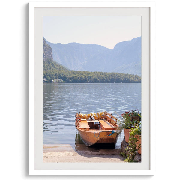 Lake house decor featuring a serene wooden boat on Lake Hallstatt, with mountains and lush greenery, perfect for tranquil spaces.