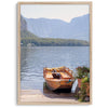 Lake house decor featuring a serene wooden boat on Lake Hallstatt, with mountains and lush greenery, perfect for tranquil spaces.