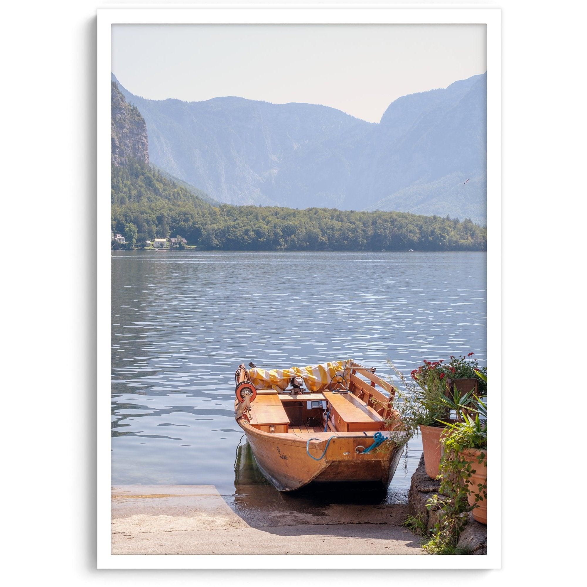 Lake house decor featuring a serene wooden boat on Lake Hallstatt, with mountains and lush greenery, perfect for tranquil spaces.