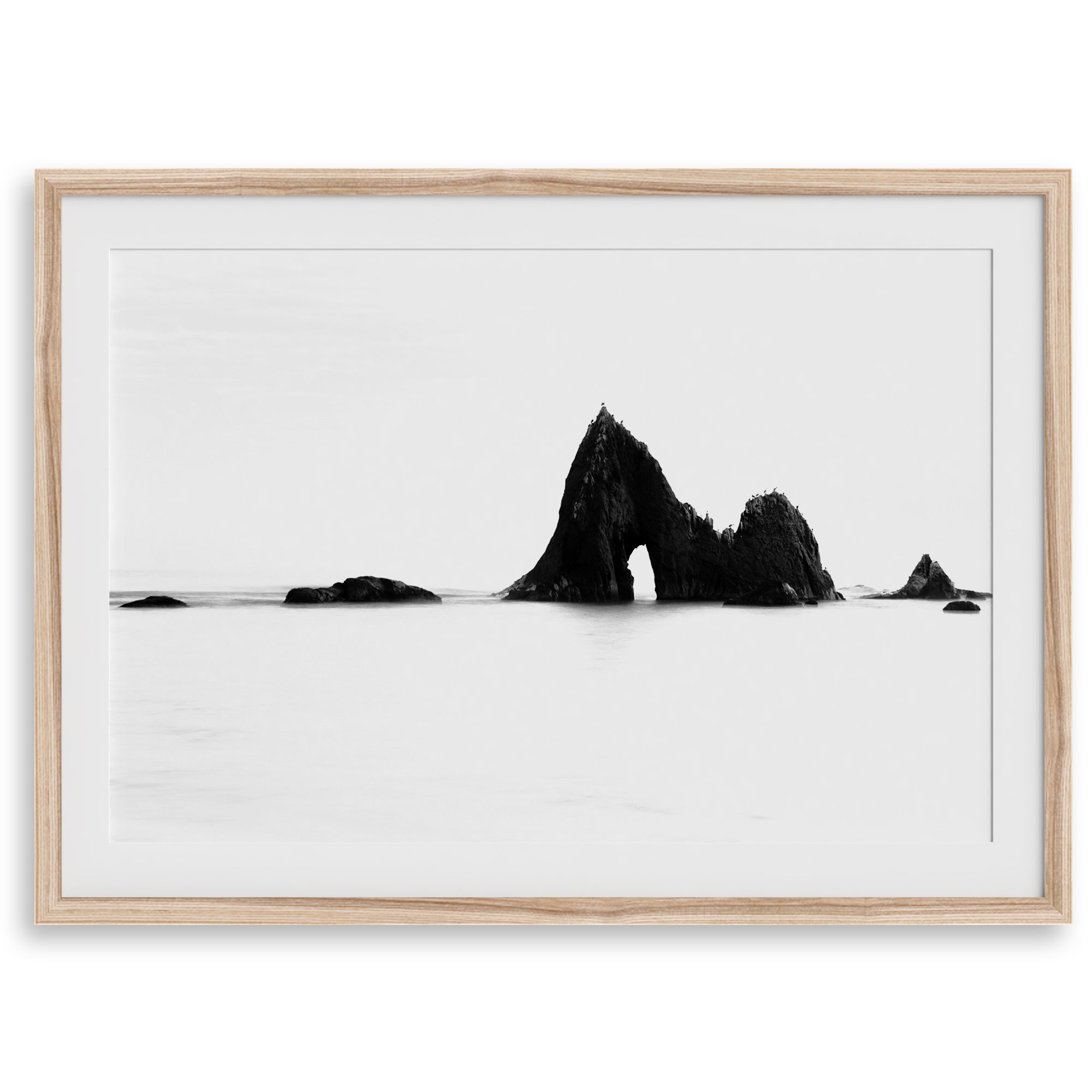 Black and white minimalist seascape print featuring a dramatic ocean arch along California’s Highway 1, perfect for modern coastal wall art.