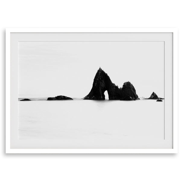 Black and white minimalist seascape print featuring a dramatic ocean arch along California’s Highway 1, perfect for modern coastal wall art.