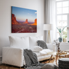 Monument Valley desert landscape print with towering sandstone buttes and a vibrant sunset sky, available as framed or canvas wall art.