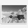 Black and white mountain cabin wall art with helicopter over snowy Denali peaks, Alaska winter landscape photography print.