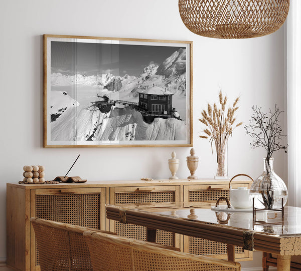Black and white mountain cabin wall art with helicopter over snowy Denali peaks, Alaska winter landscape photography print.