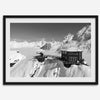 Black and white mountain cabin wall art with helicopter over snowy Denali peaks, Alaska winter landscape photography print.
