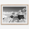 Black and white mountain cabin wall art with helicopter over snowy Denali peaks, Alaska winter landscape photography print.