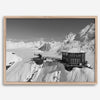 Black and white mountain cabin wall art with helicopter over snowy Denali peaks, Alaska winter landscape photography print.