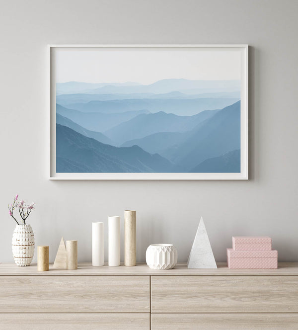 A fine art mountain photography print showing tens of shaded mountains one after the other. This minimalist mountain range wall art is perfect for nature lovers.