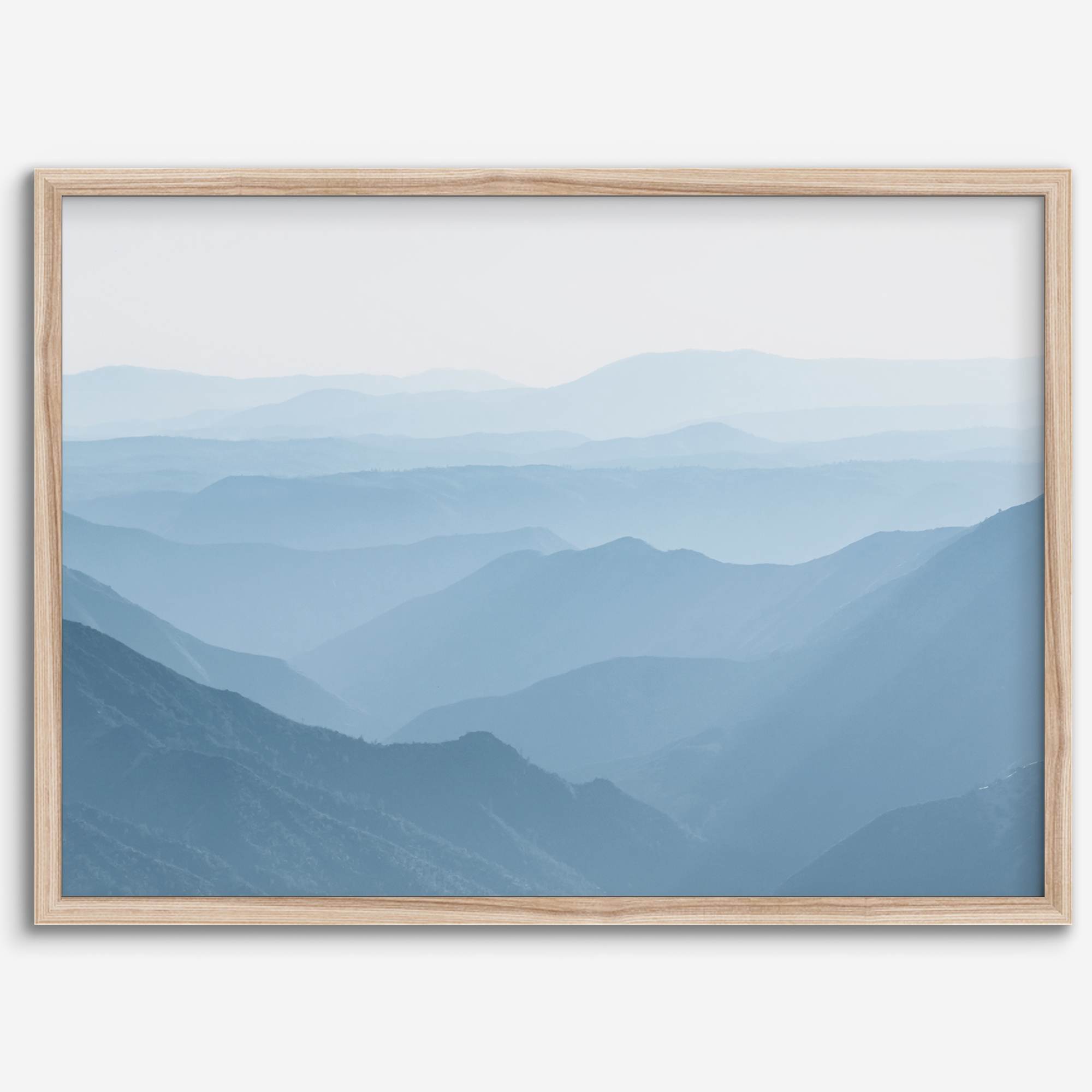 A fine art mountain photography print showing tens of shaded mountains one after the other. This minimalist mountain range wall art is perfect for nature lovers.