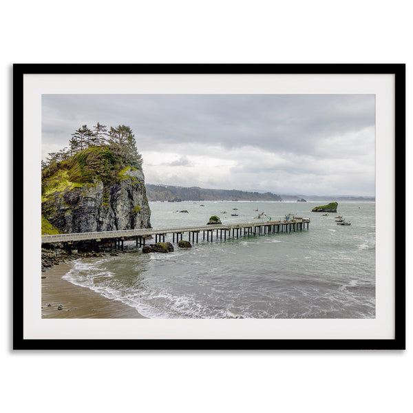 Scenic Pacific Northwest wall art of Trinidad State Park in California, showcasing a coastal pier, lush green cliffs, and calm ocean waves under cloudy skies.