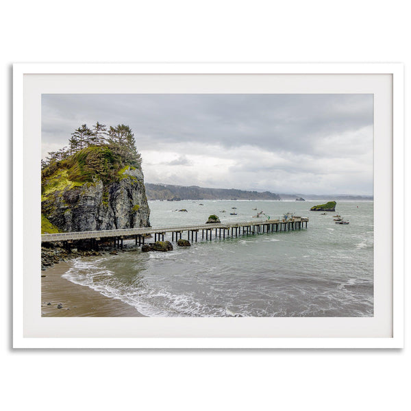 Scenic Pacific Northwest wall art of Trinidad State Park in California, showcasing a coastal pier, lush green cliffs, and calm ocean waves under cloudy skies.