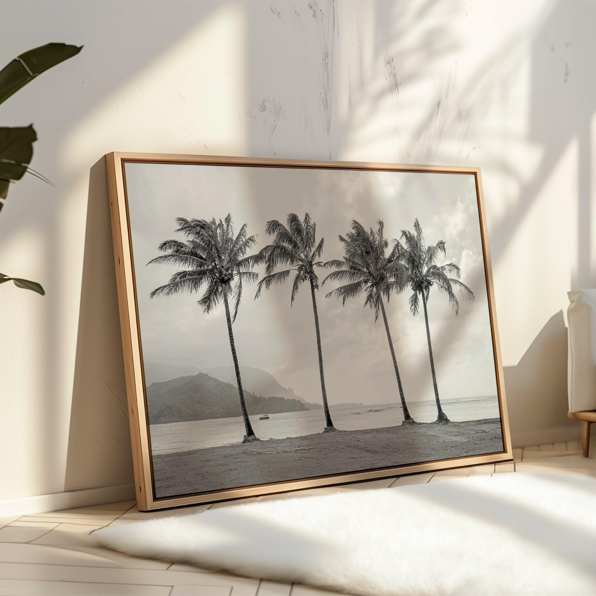 Black and white canvas print of four tall palm trees on Hanalei Bay beach in Kauai, with mountains and cloudy sky in the background.