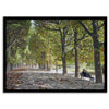 A fine art Paris print of Jardin des Tuileries in fall, featuring a couple sitting on a bench beneath vibrant autumn trees, surrounded by golden foliage.