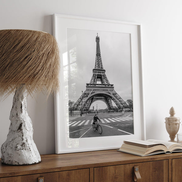 Black-and-white Eiffel Tower photo with a cyclist in the foreground, perfect for Paris wall art decor.