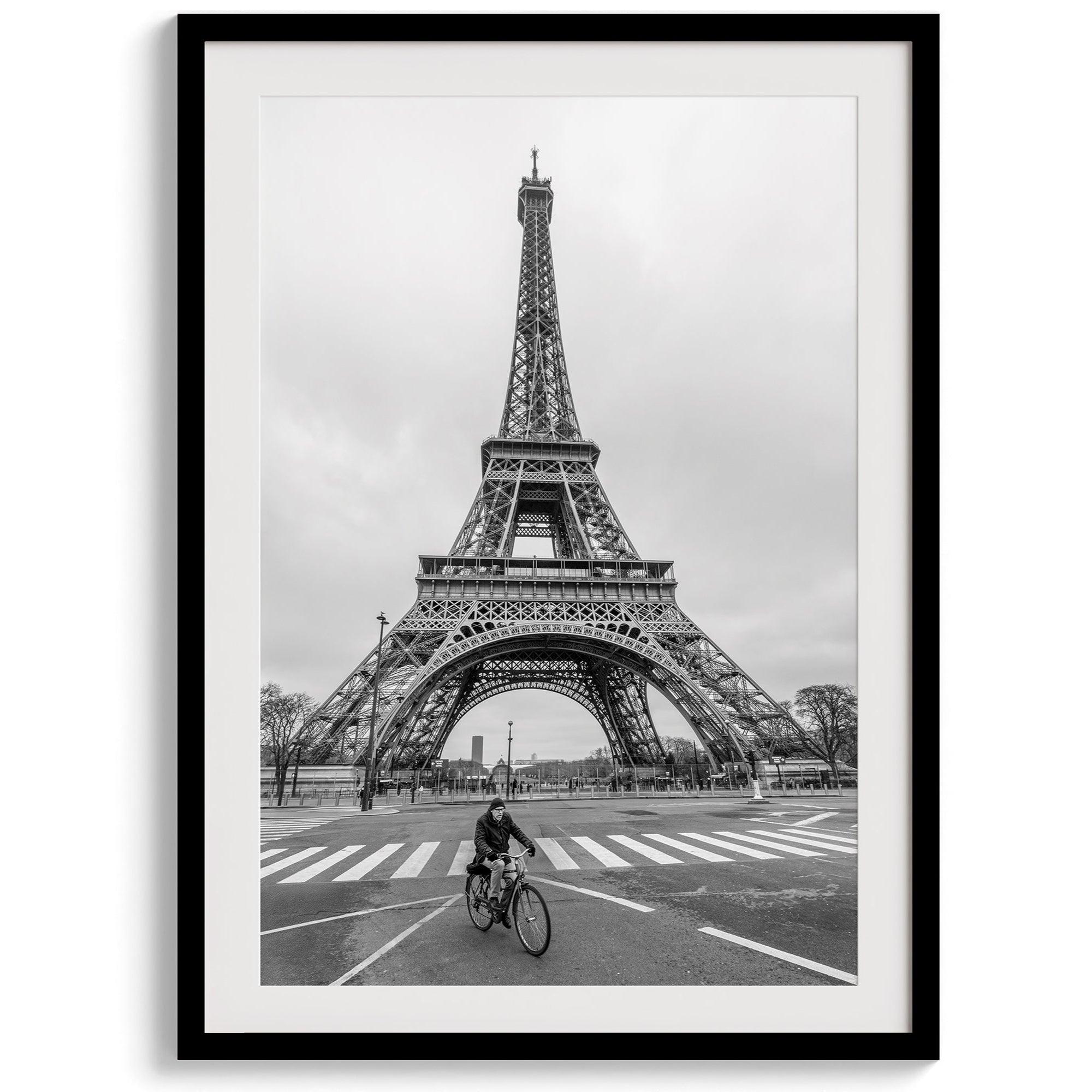 Black-and-white Eiffel Tower photo with a cyclist in the foreground, perfect for Paris wall art decor.