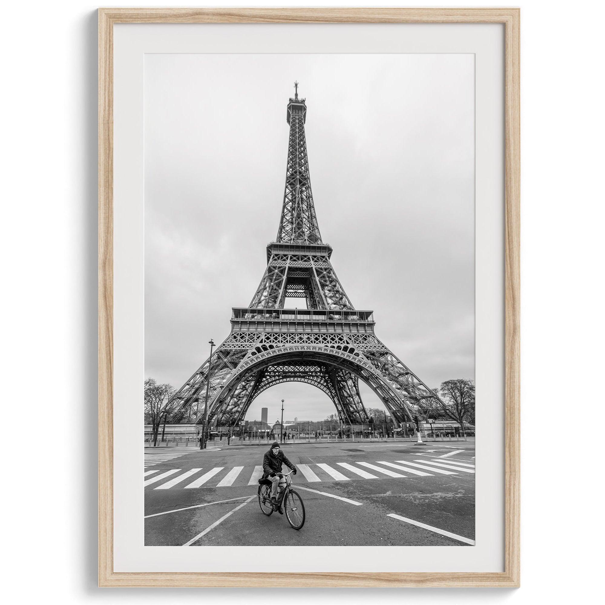 Black-and-white Eiffel Tower photo with a cyclist in the foreground, perfect for Paris wall art decor.