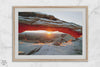 Canyonlands wall art featuring Mesa Arch at sunrise, with sunlight shining through the snow-covered arch over a vast canyon landscape.