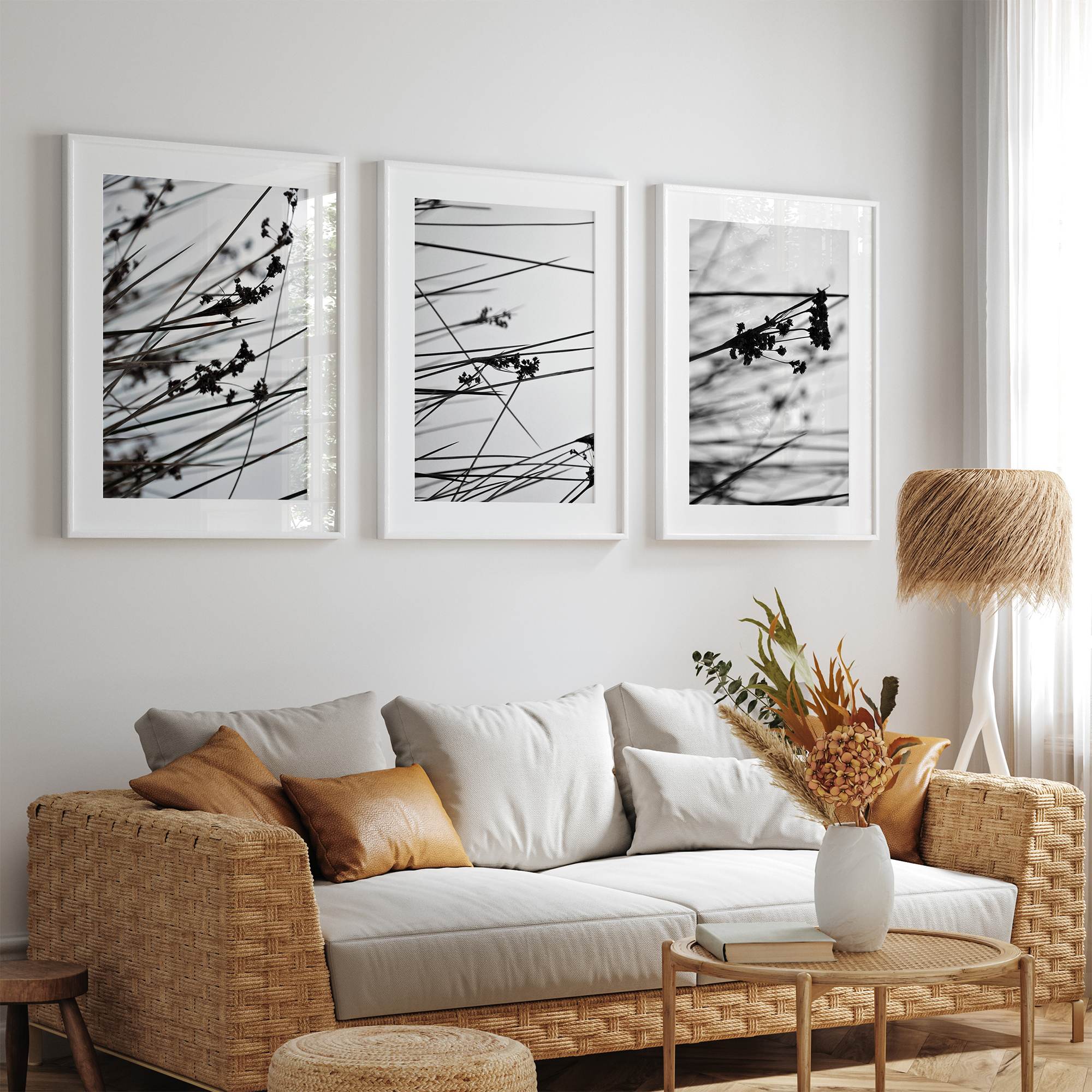 Minimalist black and white floral triptych with abstract plant silhouettes and delicate botanical linework.