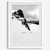 A fine art print showing five skiers traversing a vast, snowy mountain landscape under a pale winter sky, surrounded by untouched wilderness.