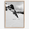 A fine art print showing five skiers traversing a vast, snowy mountain landscape under a pale winter sky, surrounded by untouched wilderness.