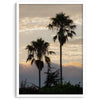 Palm tree wall art featuring two palms silhouetted at sunrise with soft golden light.