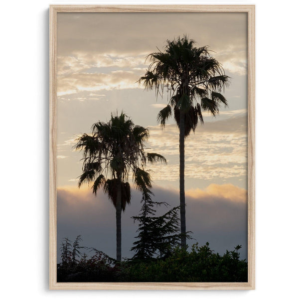 Palm tree wall art featuring two palms silhouetted at sunrise with soft golden light.