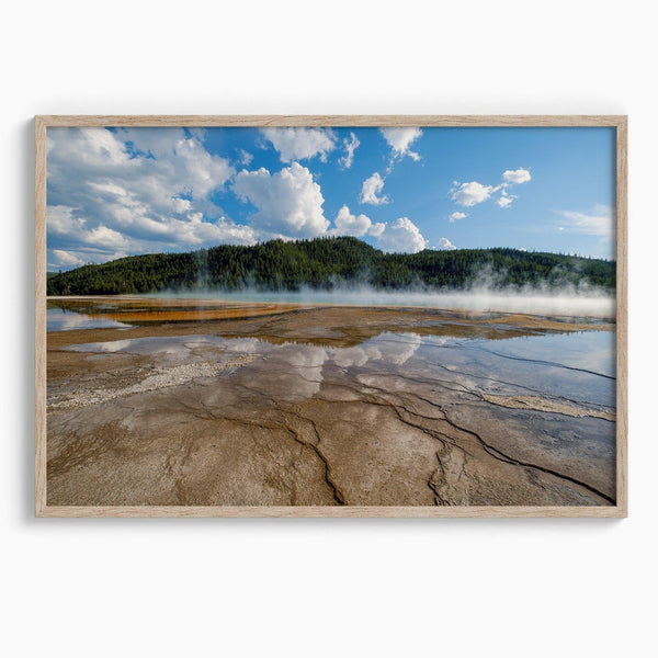 A fine art framed or unframed print of the stunning Grant Prismatic hot springs in Yellowstone National Park. This nature wall art showcases the beautiful geometrical shapes and cloud reflections in the hot spring water.