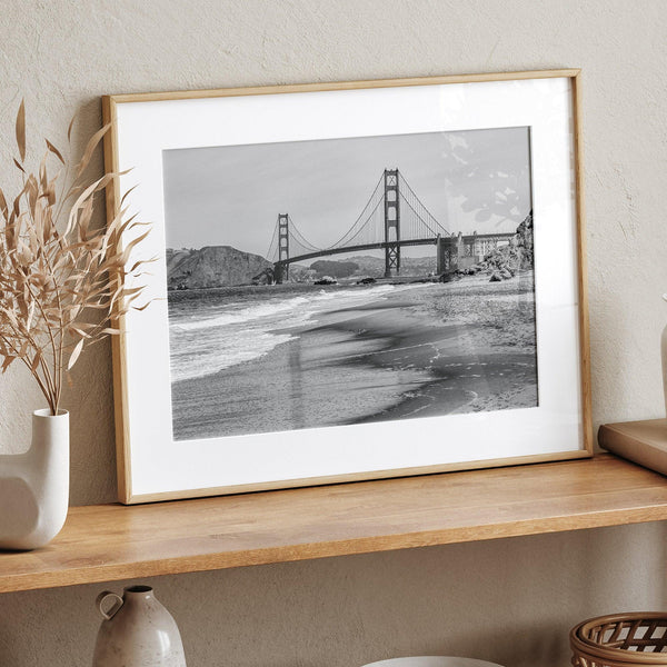 Fine art black and white print of Golden Gate Bridge from Baker Beach, San Francisco. Bridge with reflection in beach surf. Framed or unframed option available