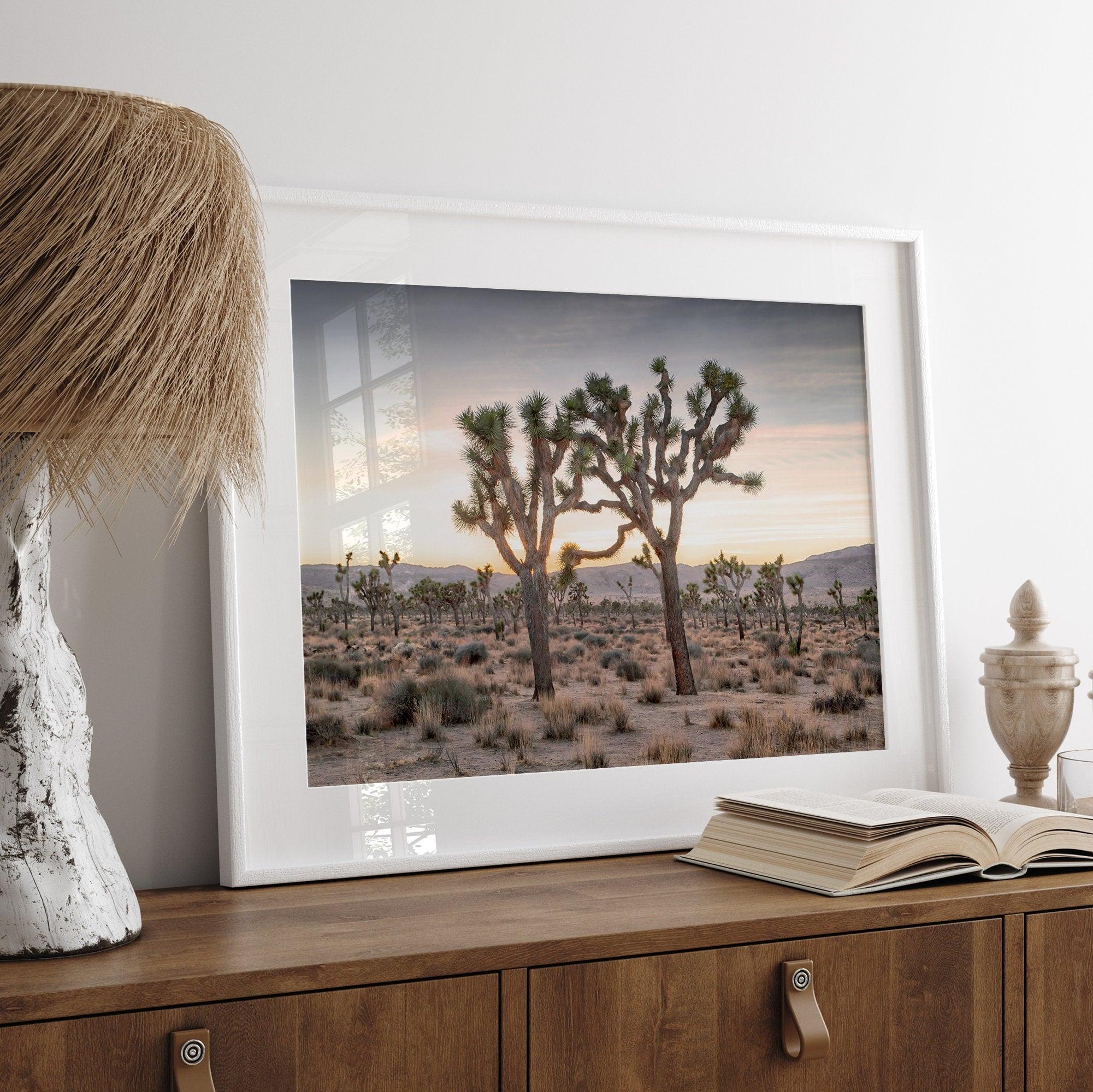 A framed fine art photography print from Joshua Tree National Park of two Joshua Trees in the Sunset. The trees appear to be holding hands. This California desert landscape wall art shows the famous Joshua Trees and desert plants in the Sunset.