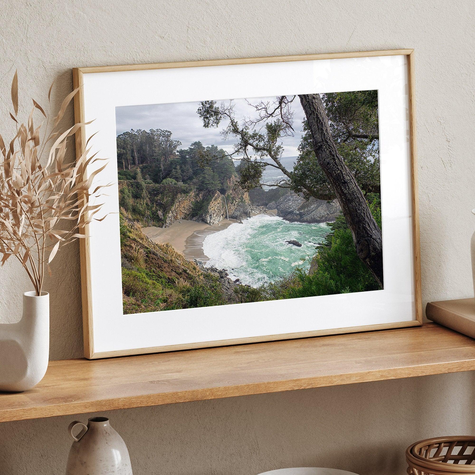 This fine art coastal ocean print features a breathtaking view of Mcway Falls in Big Sur, California, falling to the beach and into the ocean. This fine art photography print captures the beauty and wilderness of nature.