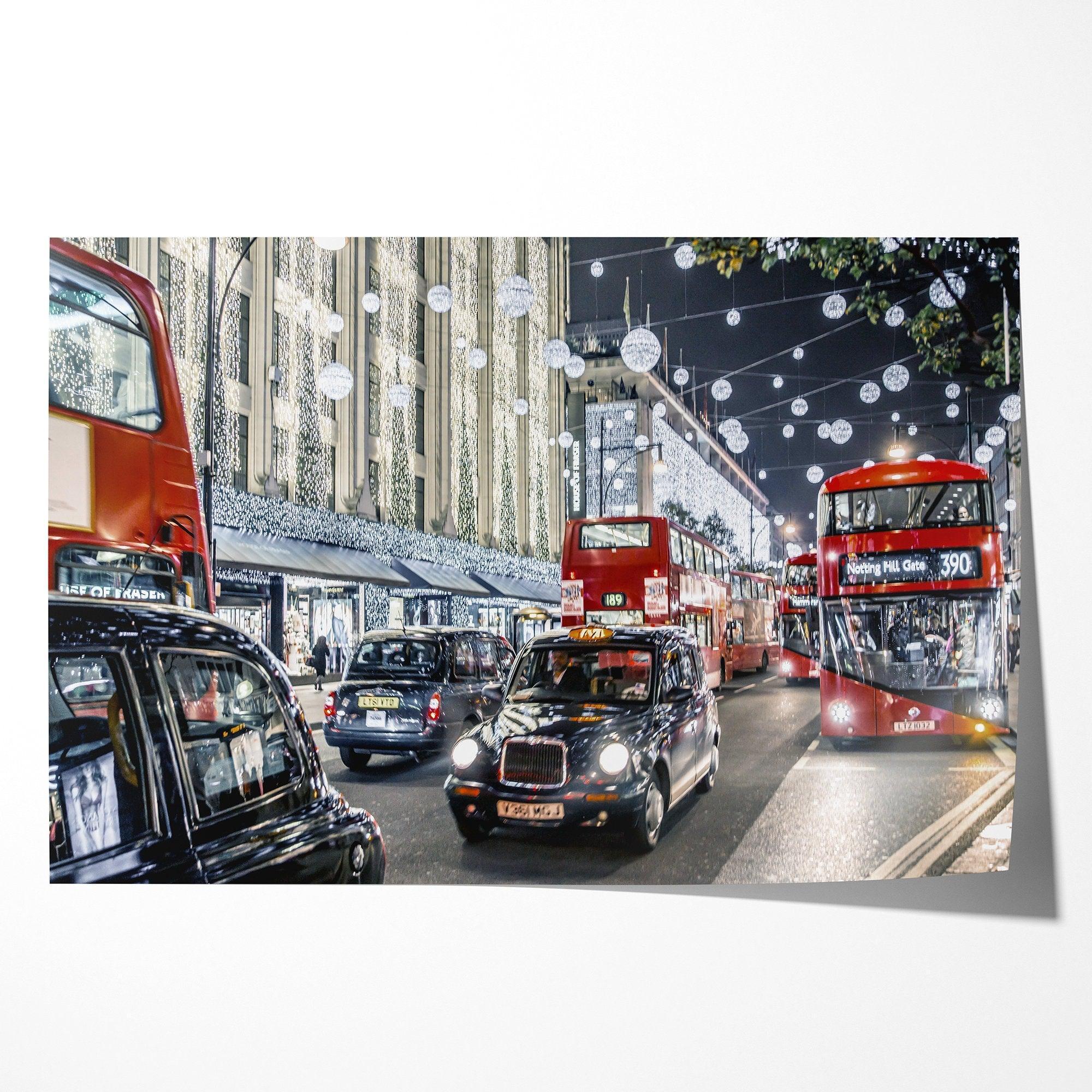 A fine art photography print of a vibrant and lively street in London during the Christmas holidays. This London wall art shows double-decker buses and black taxis, and the streets are adorned with bright holiday lights and festive decorations