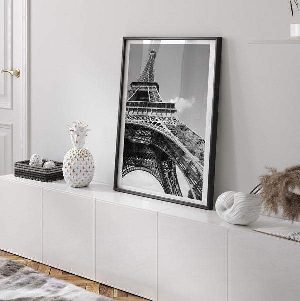 A fine art Eiffel Tower black and white print. This Paris theme wall art showcases a unique wide-angle view from the bottom of the tower, creating a modern, trendy fine art photography to hang on your walls.