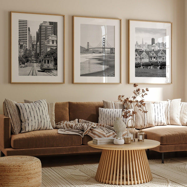A San Francisco oversized set of 3 framed or unframed wall art. The prints feature a San Francisco cable car overlooking the Bay Bridge, the Golden Gate Bridge from Baker Beach, and the famous Painted Ladies with the San Francisco skyline.