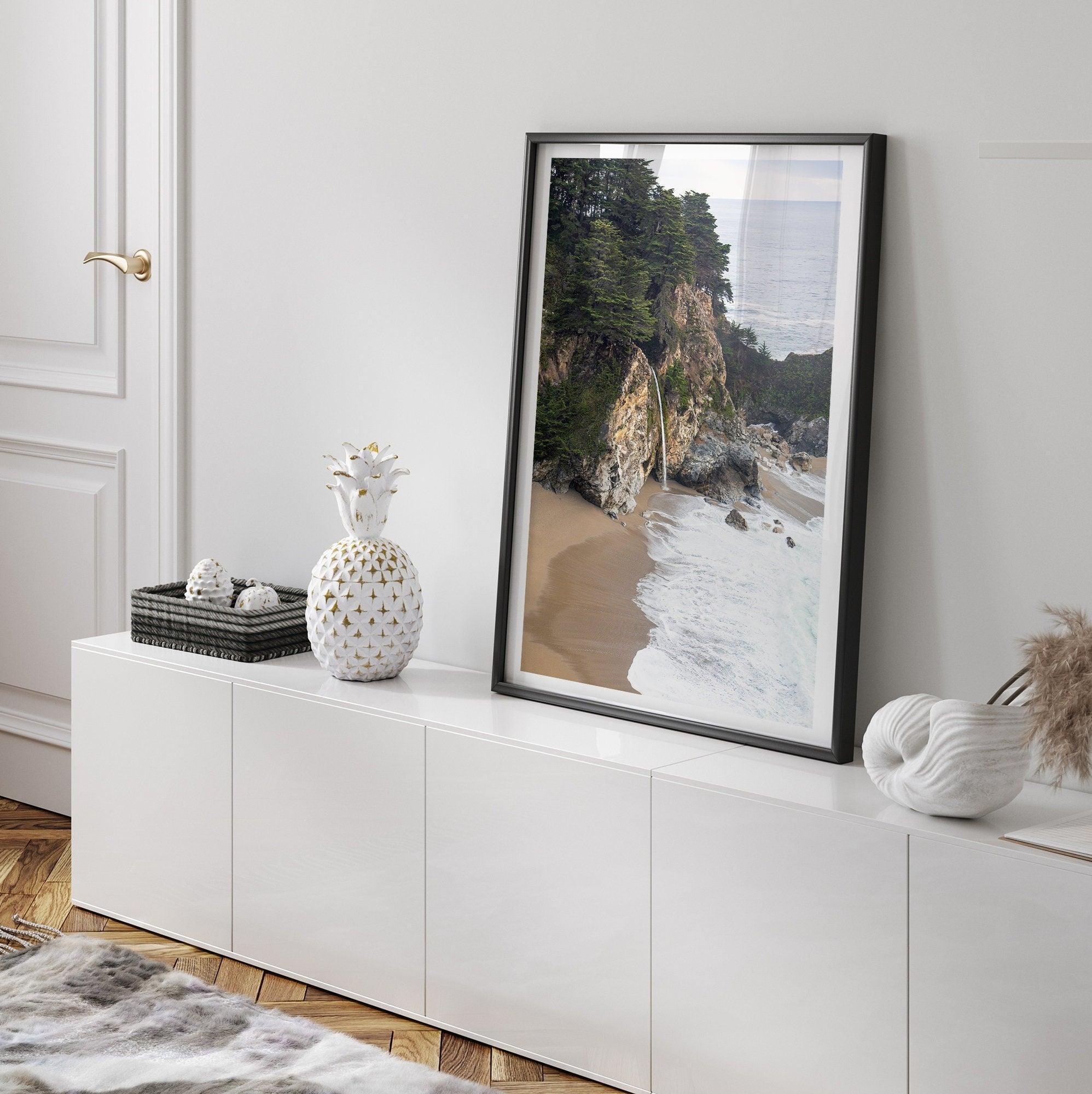 This captivating California coastal beach print captures the awe-inspiring scene of McWay Falls in Big Sur, as its creamy waterfall cascades onto a pristine beach and merges with the rhythmic dance of the ocean waves.