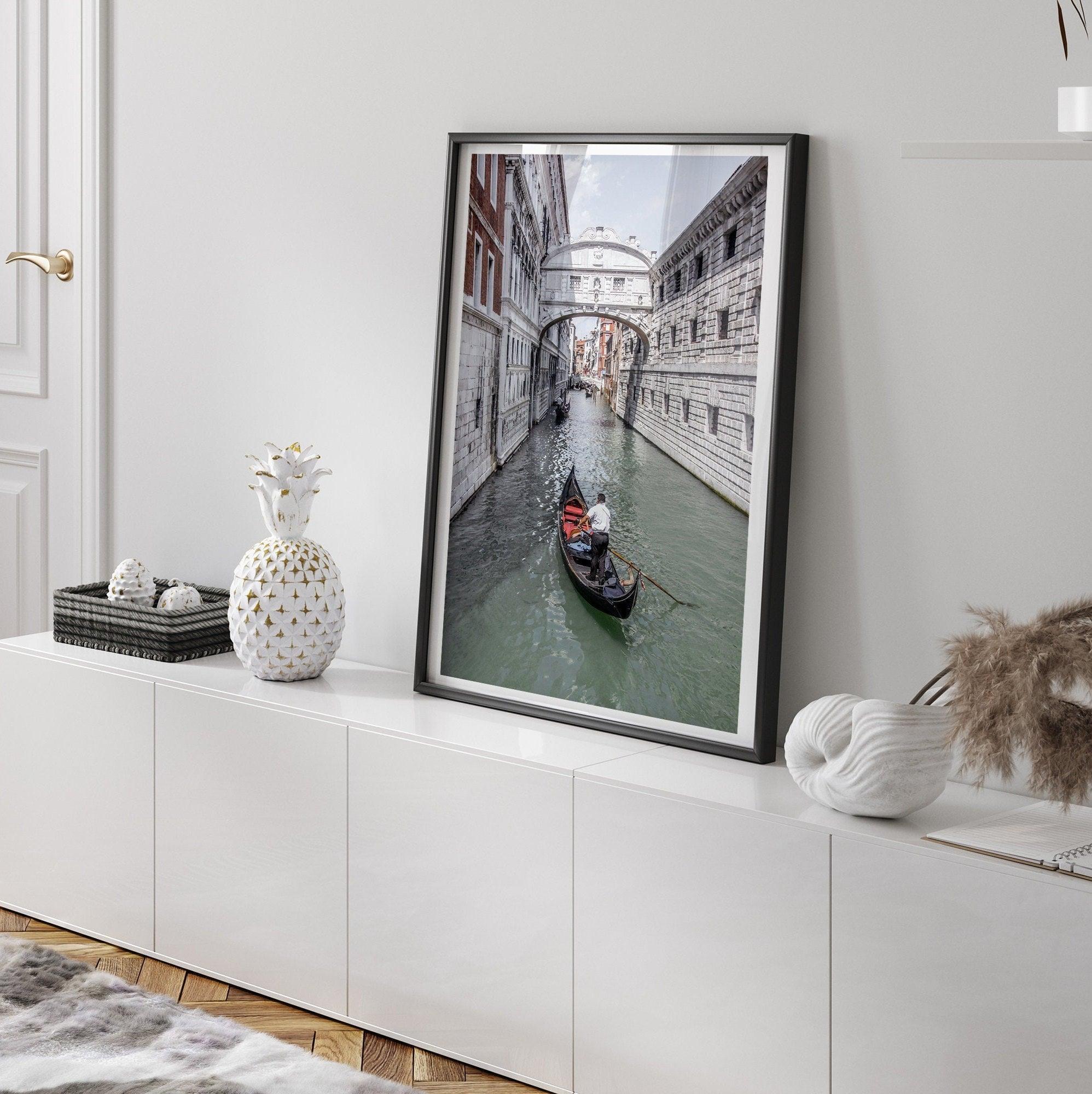 A fine art Venice travel print framed or unframed poster showcasing a Goldola sailing in one of the narrow canals of the old cities of Italy.