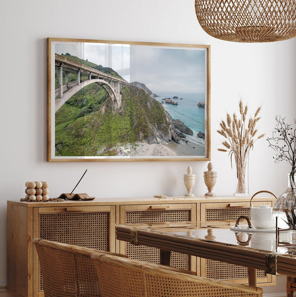 A fine art ocean print of one of the most iconic spots in the famous Route 1 in California - Bixby Bridge near Big Sur. Shot in a unique wide angle that captures the bridge, cliffs, the ocean, and the stunning beach below.