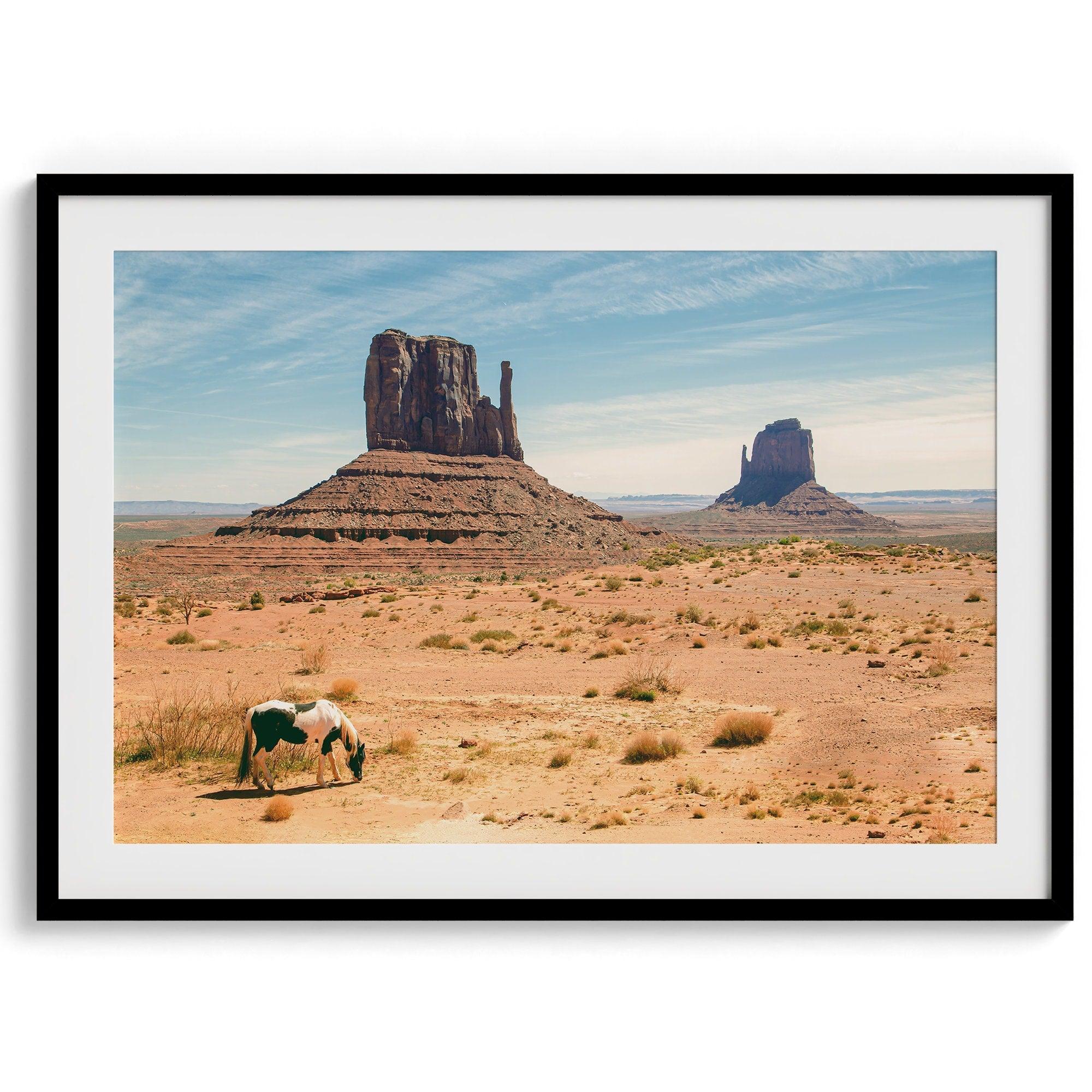 A framed or unframed fine art photography desert print of a horse in monument valley, Utah. This wall art features unique rock formations native to the Monument Valley area. This horse wall art comes in different sizes, including extra large.