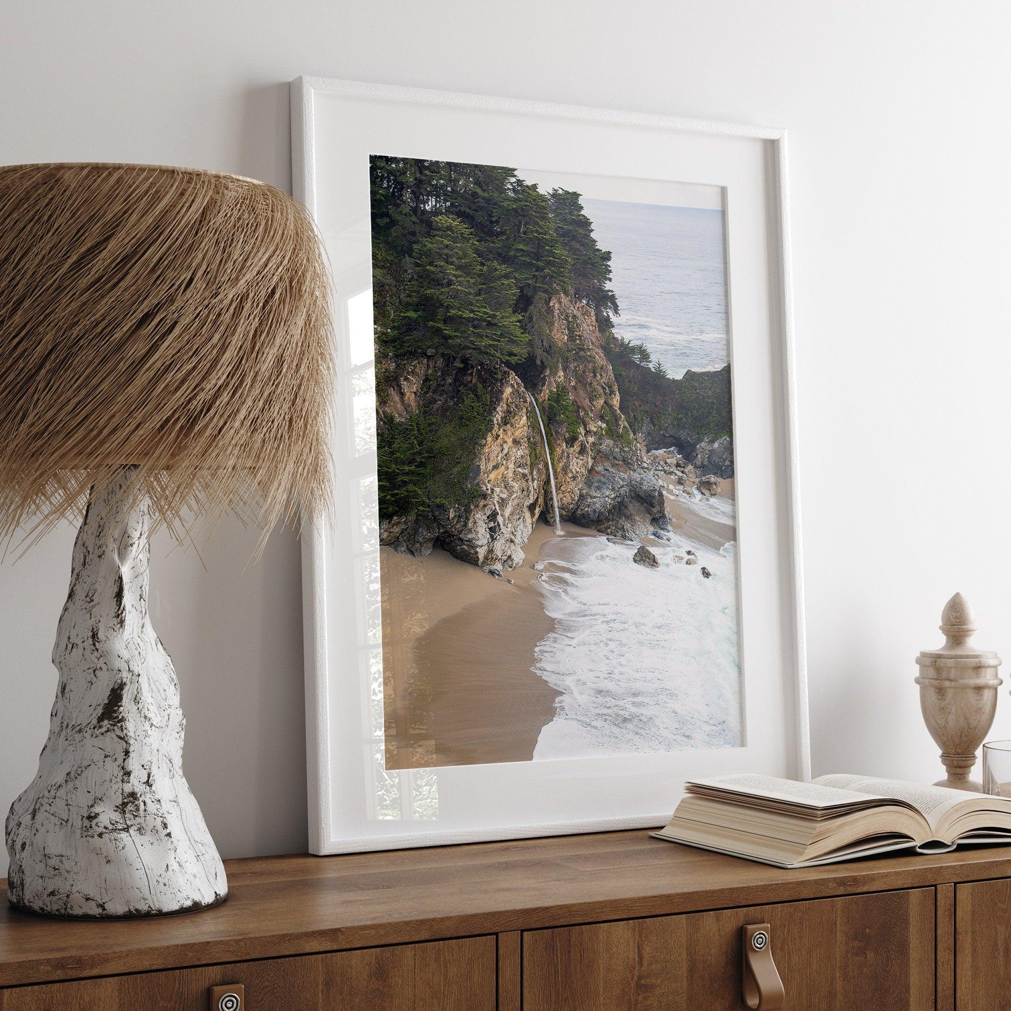 This captivating California coastal beach print captures the awe-inspiring scene of McWay Falls in Big Sur, as its creamy waterfall cascades onto a pristine beach and merges with the rhythmic dance of the ocean waves.