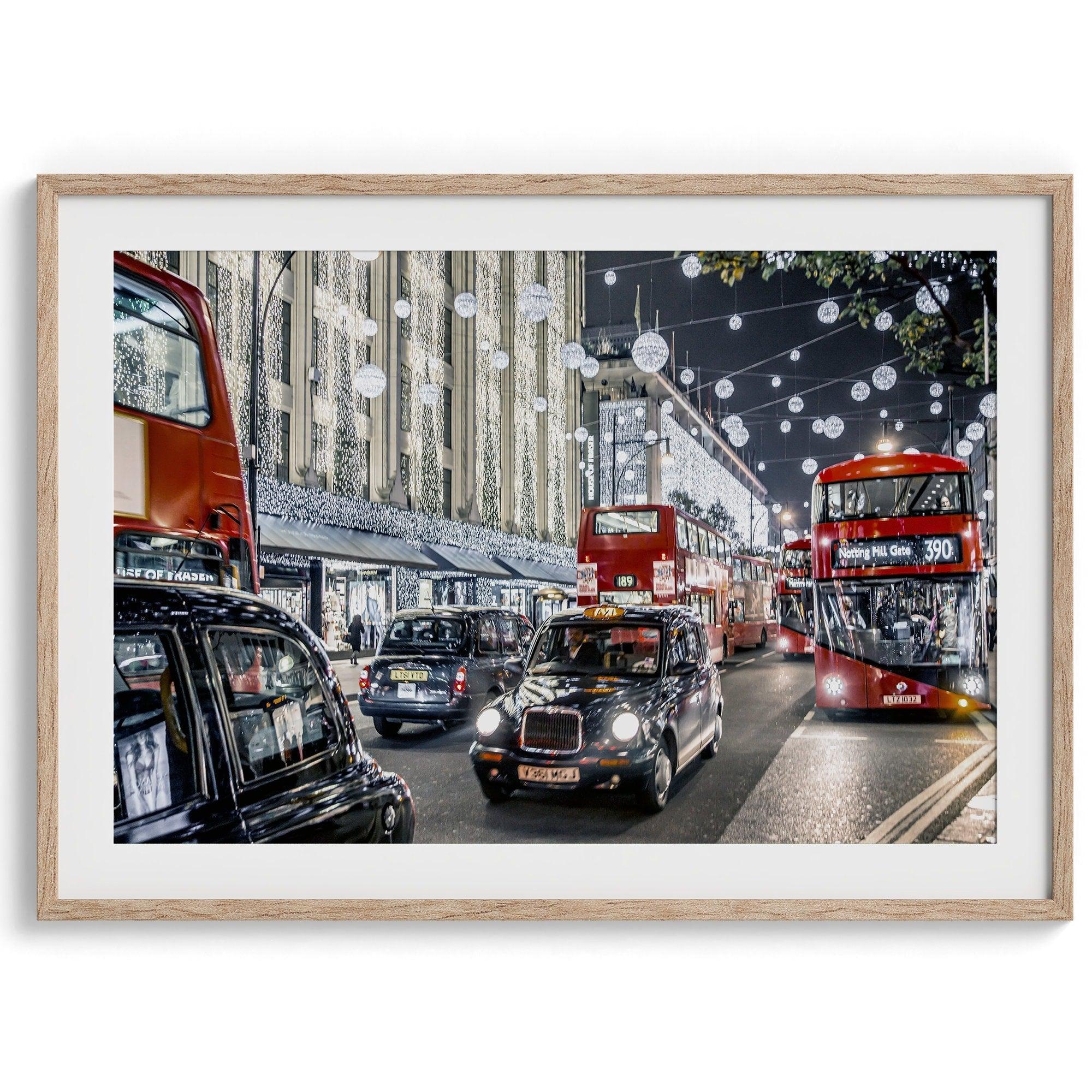 A fine art photography print of a vibrant and lively street in London during the Christmas holidays. This London wall art shows double-decker buses and black taxis, and the streets are adorned with bright holiday lights and festive decorations