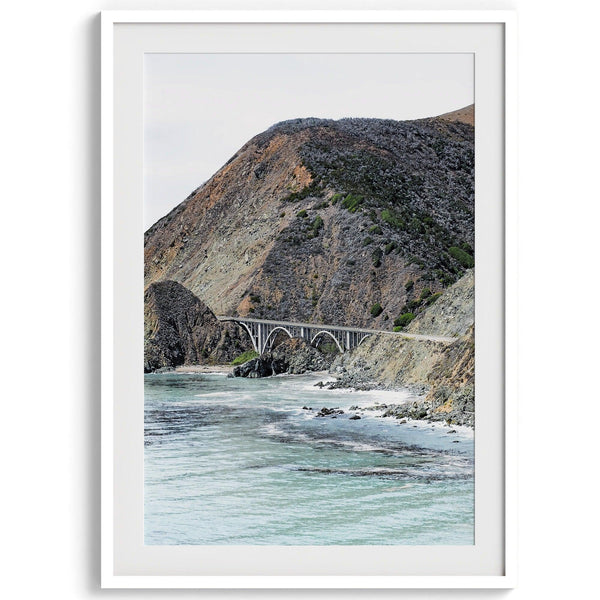 This California coastal print features the famous Bixby Bridge in Route 1, near Big Sur, In this Northwest Coast wall art you can see the ocean surf crashing against the coastal cliffs with the breathtaking old bridge in the center.