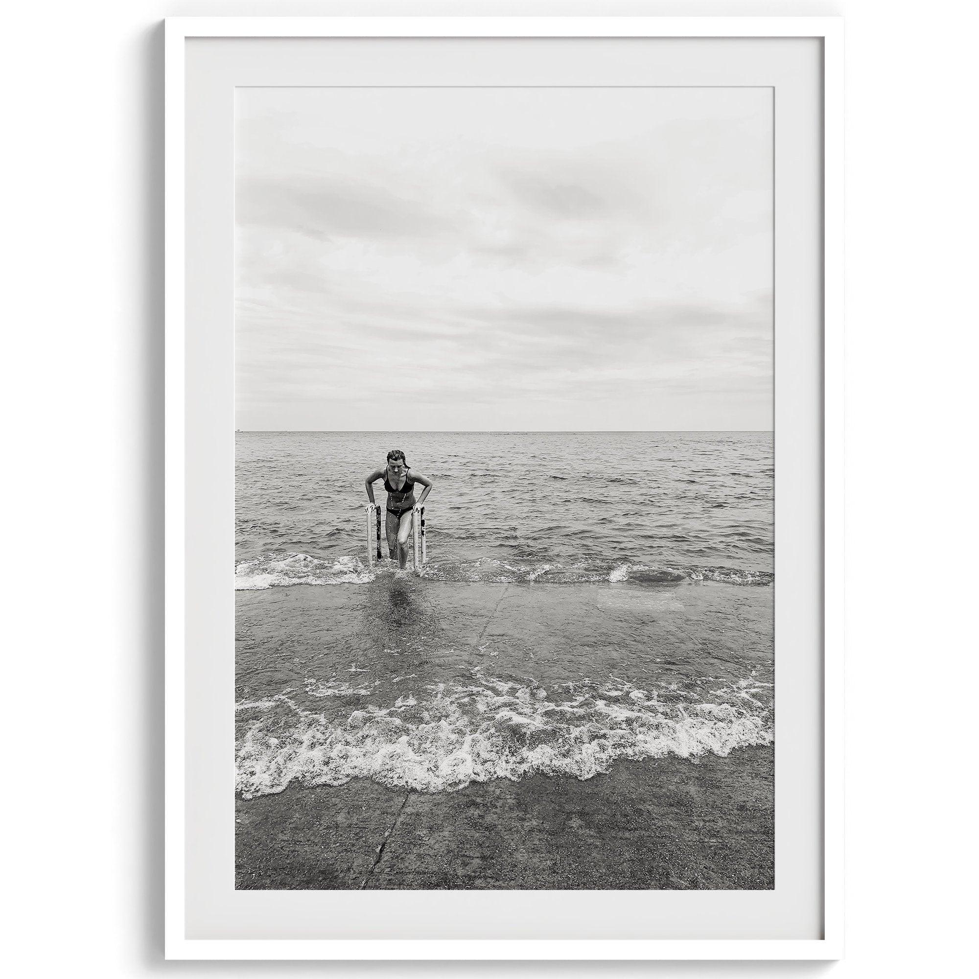 A black and white fine art lake beach print of a beach in Chicago on the coast of Lake Michigan showcasing a woman bathing in the lake. The classic modern look of the print is sure to impress when hung on your walls.